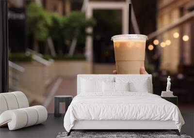 Woman holding takeaway plastic cup with cold coffee drink outdoors, closeup. Space for text Wall mural