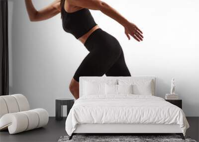 Woman in sportswear running on white background Wall mural