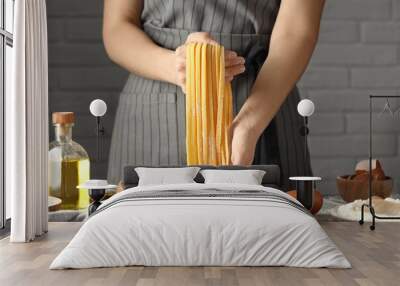 Woman making homemade pasta at table, closeup Wall mural