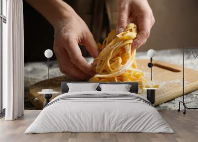 Woman preparing pasta at table, closeup view Wall mural