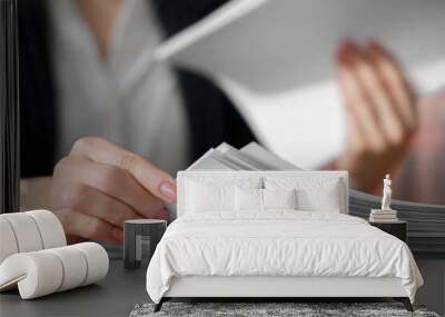 Woman reading documents at table in office, closeup. Space for text Wall mural