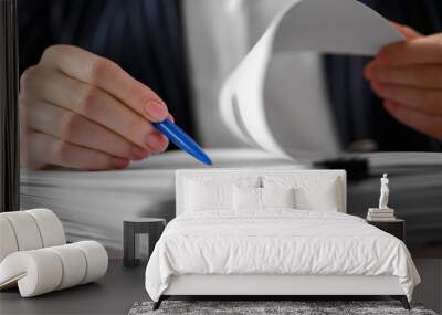 Woman signing documents at table in office, closeup Wall mural