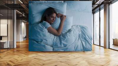 Woman sleeping in bed at night, above view. Space for text Wall mural