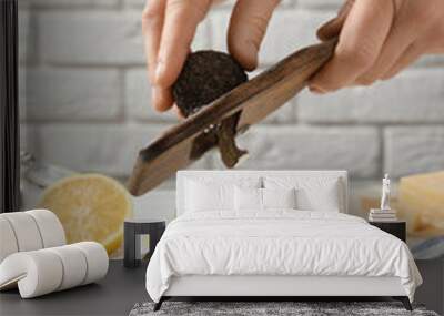 Woman slicing truffle over delicious pasta at white table, closeup Wall mural