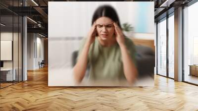 Woman suffering from headache indoors, motion blur effect Wall mural