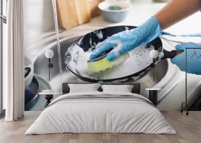 Woman washing dirty frying pan in sink indoors, closeup Wall mural