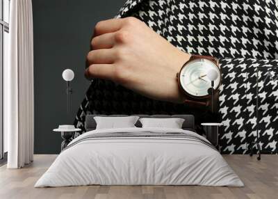 Woman wearing luxury wristwatch on grey background, closeup Wall mural