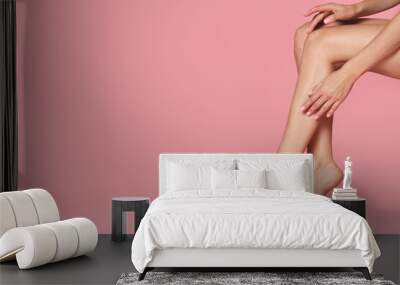 Woman with beautiful long legs on pink background, closeup. Space for text Wall mural