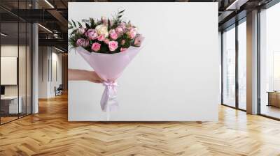 Woman with bouquet of beautiful roses on light background, closeup. Space for text Wall mural