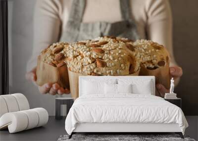 Woman with delicious Italian Easter dove cake (traditional Colomba di Pasqua) near grey wall, closeup Wall mural