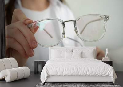 woman with glasses on light background, closeup Wall mural