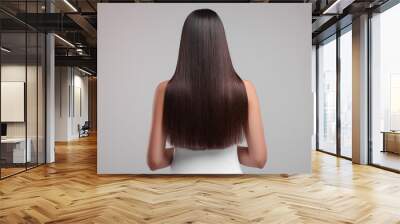 Woman with healthy hair after treatment on light gray background, back view Wall mural