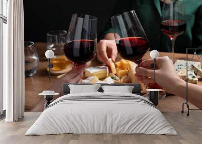 Women toasting with glasses of wine near cheese plate, closeup Wall mural