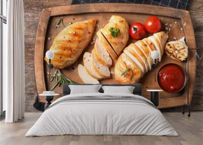 Wooden board with fried chicken breasts and sauce on table, top view Wall mural