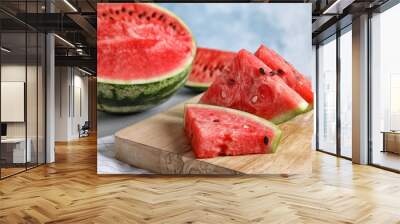 Wooden board with juicy watermelon slices on table Wall mural