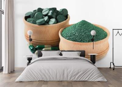 Wooden bowls of spirulina pills and powder on white background Wall mural