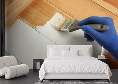 Worker applying white paint onto wooden surface, above view. Space for text Wall mural