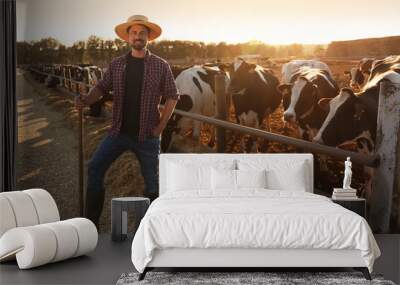 Worker with shovel near cow pen on farm. Animal husbandry Wall mural