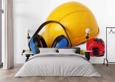 Yellow hard hat, earmuffs and measuring tape isolated on white. Construction tools Wall mural