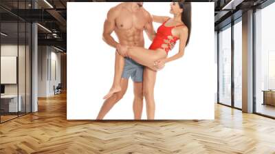 Young attractive couple in beachwear dancing on white background Wall mural