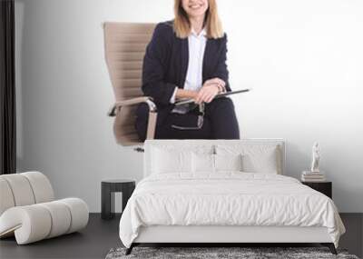 Young businesswoman with laptop sitting in office chair on white background Wall mural