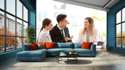 Young couple meeting with consultant in office Wall mural