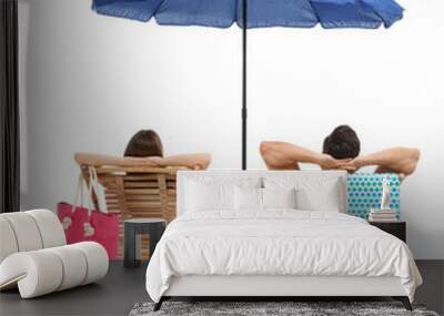 Young couple with beach accessories on sun loungers against white background Wall mural