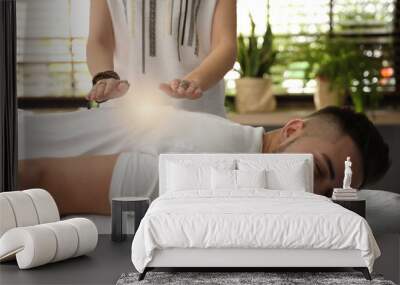 Young man during healing session in therapy room Wall mural