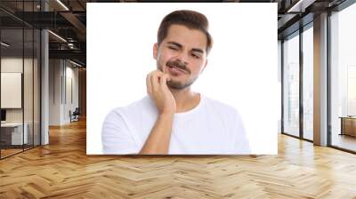 Young man scratching face on white background. Annoying itch Wall mural