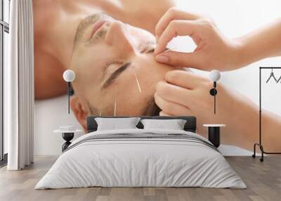 Young man undergoing acupuncture treatment in salon, closeup Wall mural