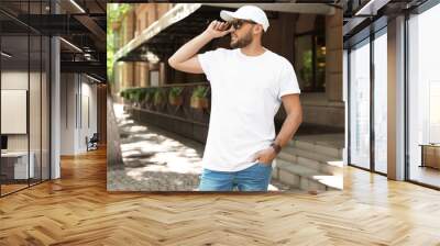 Young man wearing white t-shirt on street Wall mural