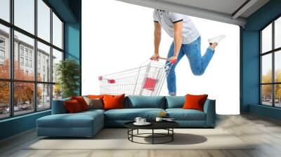 Young man with empty shopping cart on white background Wall mural