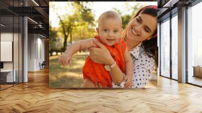 Young mother with her cute baby in park on sunny day Wall mural