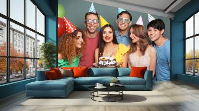 Young people celebrating birthday with tasty cake on color background Wall mural