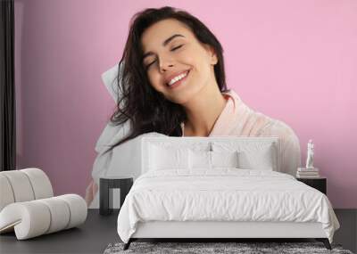 Young woman drying hair with towel on pink background Wall mural