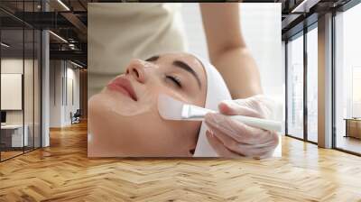 Young woman during face peeling procedure in salon Wall mural