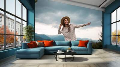 Young woman enjoying her time in mountains Wall mural