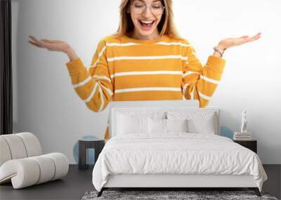 Young woman in casual outfit with laptop sitting on white background Wall mural