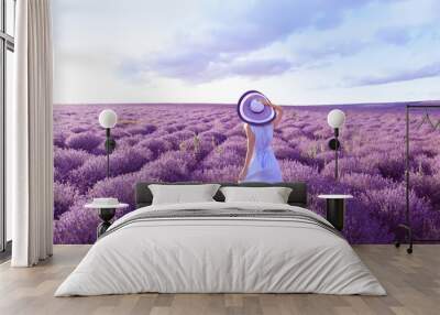 young woman in lavender field on summer day Wall mural