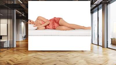 Young woman lying on soft mattress against white background Wall mural