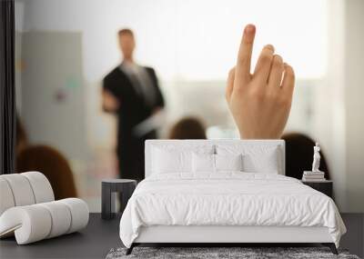 Young woman raising hand to ask question at business training indoors, closeup Wall mural