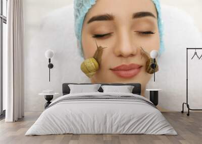 Young woman receiving snail facial massage in spa salon, closeup Wall mural