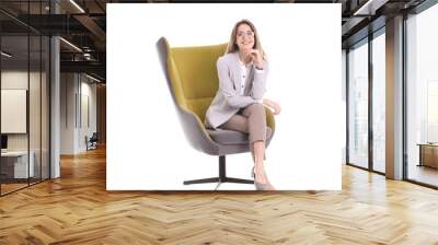 Young woman sitting in armchair on white background Wall mural