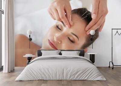 Young woman undergoing acupuncture treatment in salon Wall mural