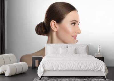 Young woman with beautiful face on white background Wall mural