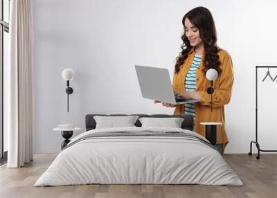 Young woman with laptop on white background Wall mural