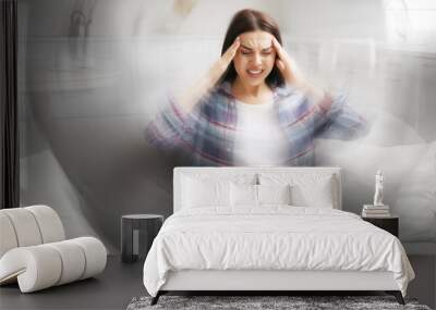 Young woman with laptop suffering from migraine at home Wall mural