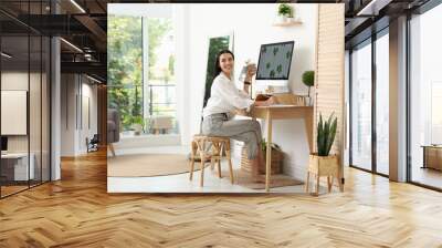 Young woman working at table in light room. Home office Wall mural