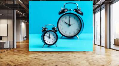 black vintage alarm clock on color background Wall mural