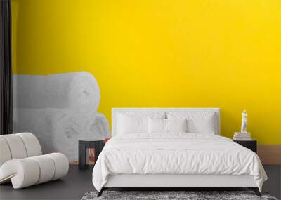 Clean soft towels on color background Wall mural